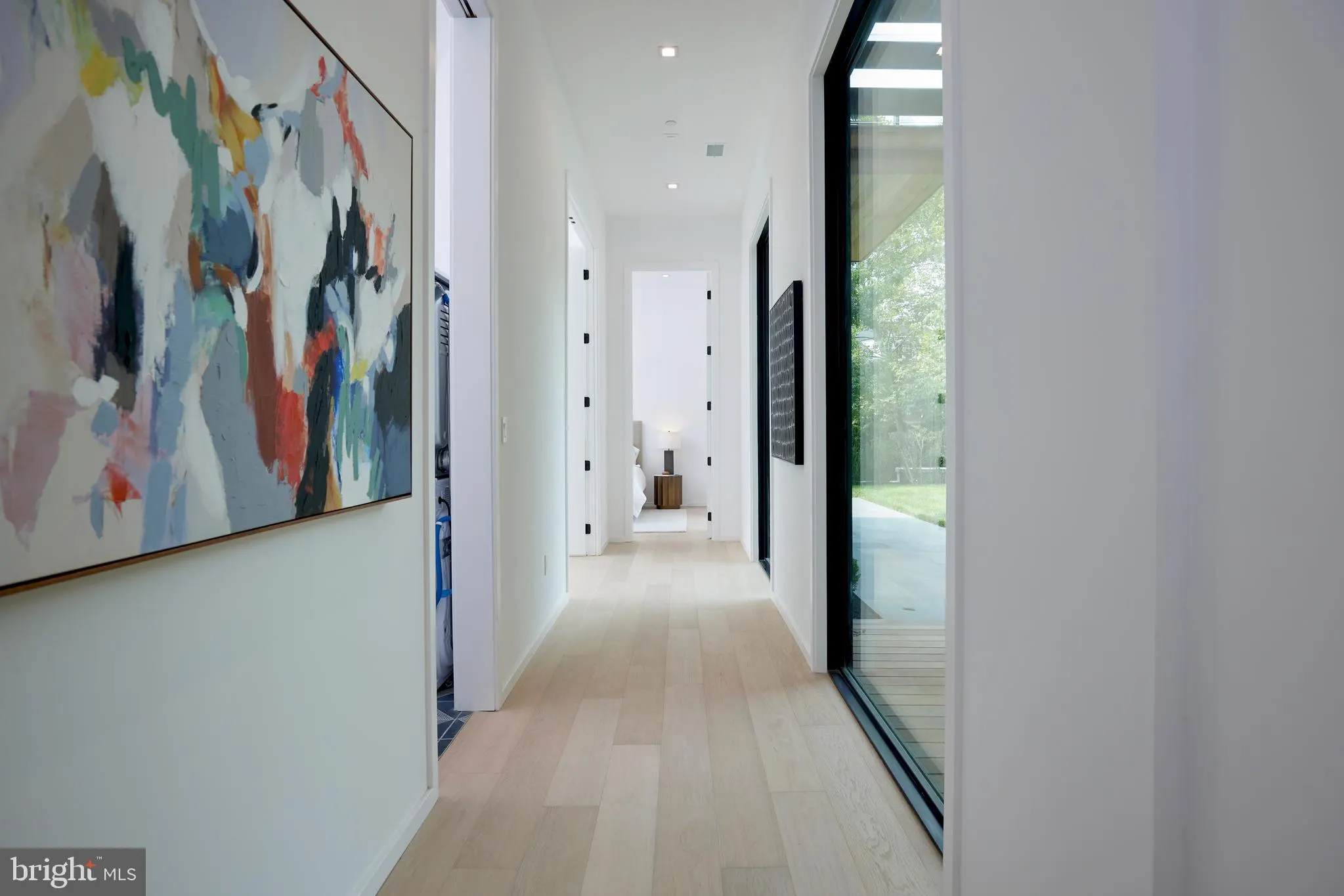 Front elevation with a glass garage door and gravel drive
