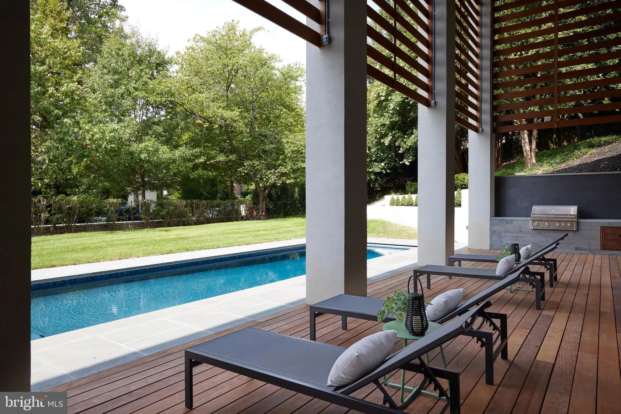 Side yard with the lap pool and lawn running along the house