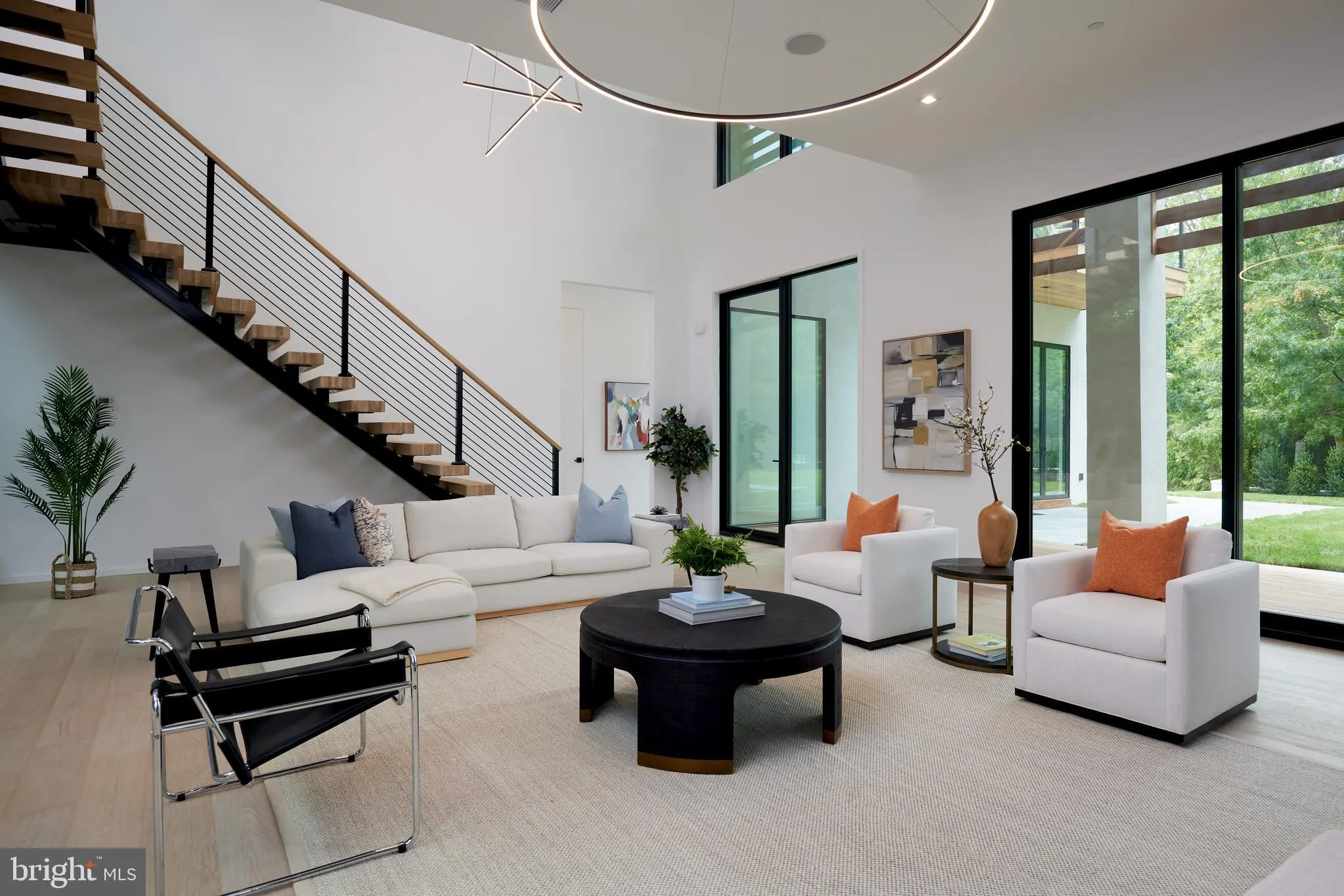 Dining area with a wood table, gray stone fireplace wall, and cluster pendant lighting