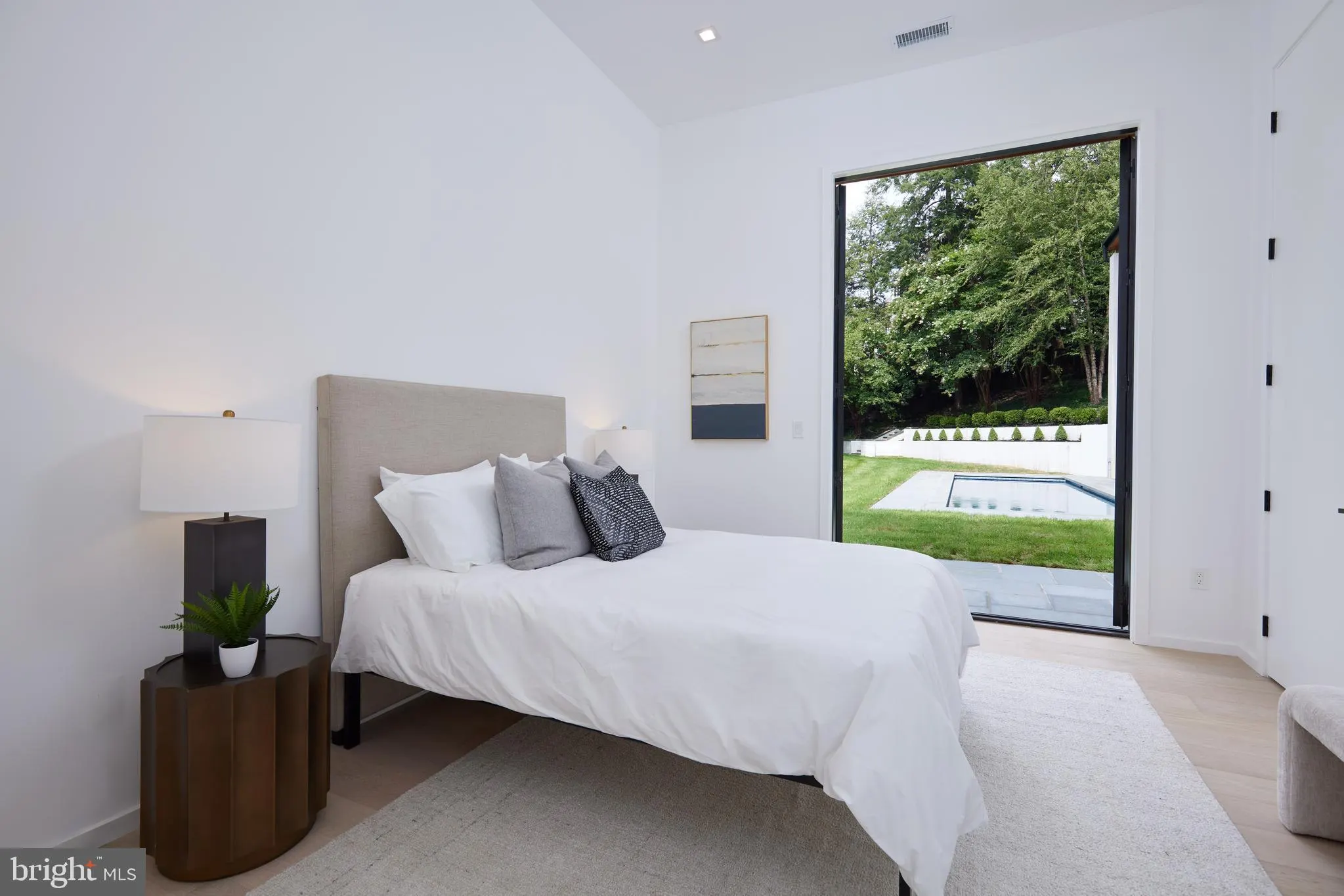 Covered loggia with chaise lounges beside the lap pool