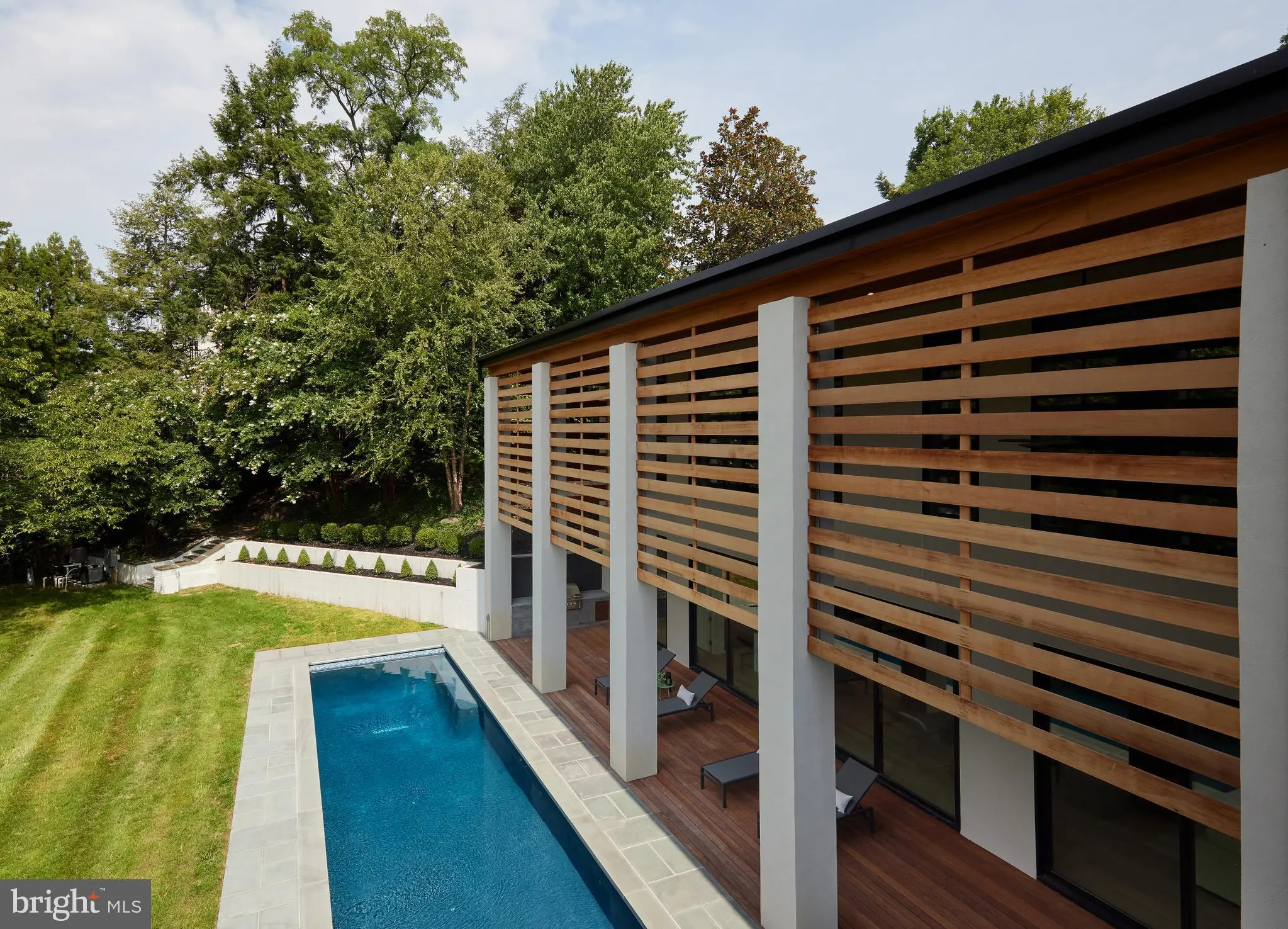 Primary bath with a freestanding tub, navy tile, and a glass shower