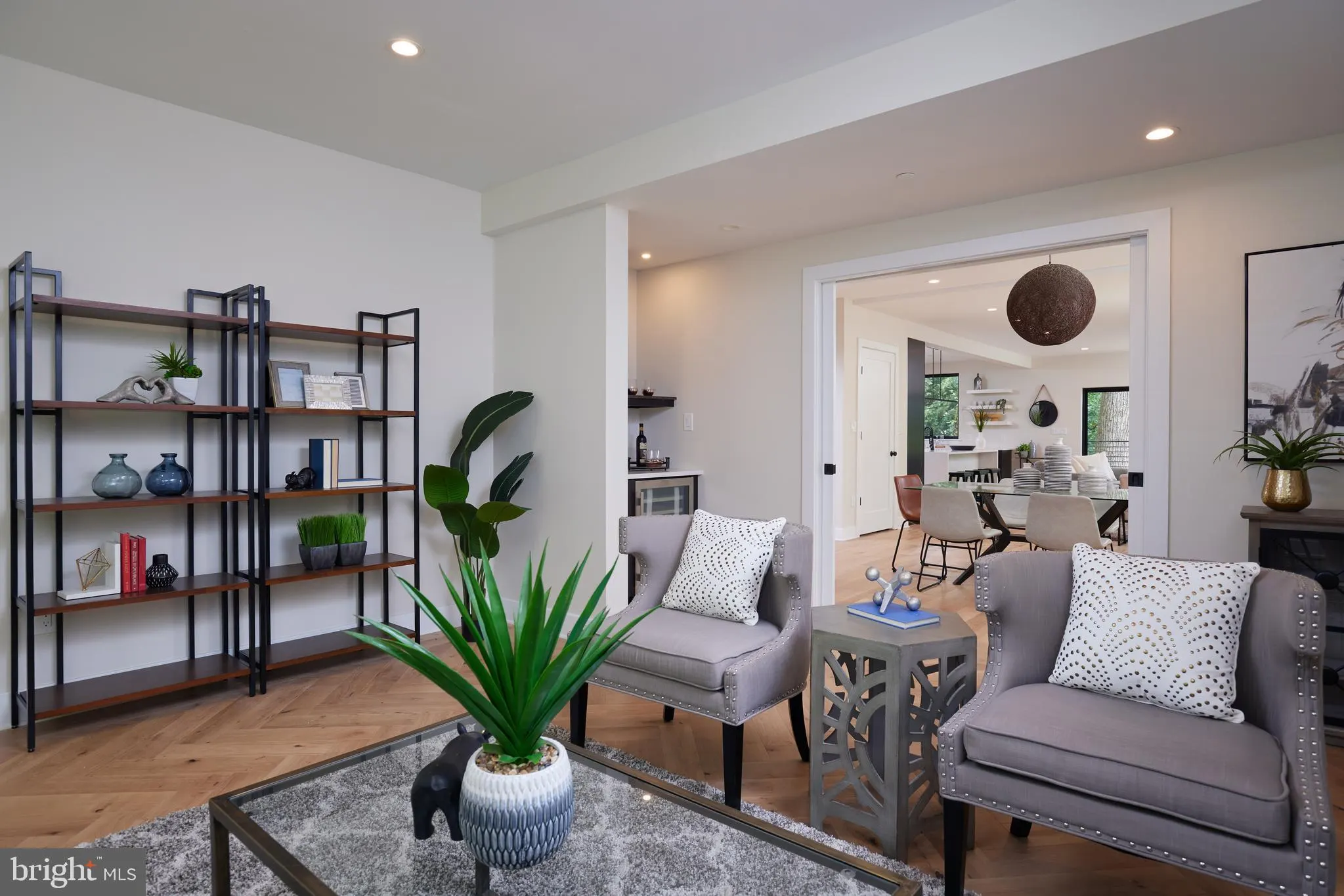 Open-concept living space with office area visible through doorway