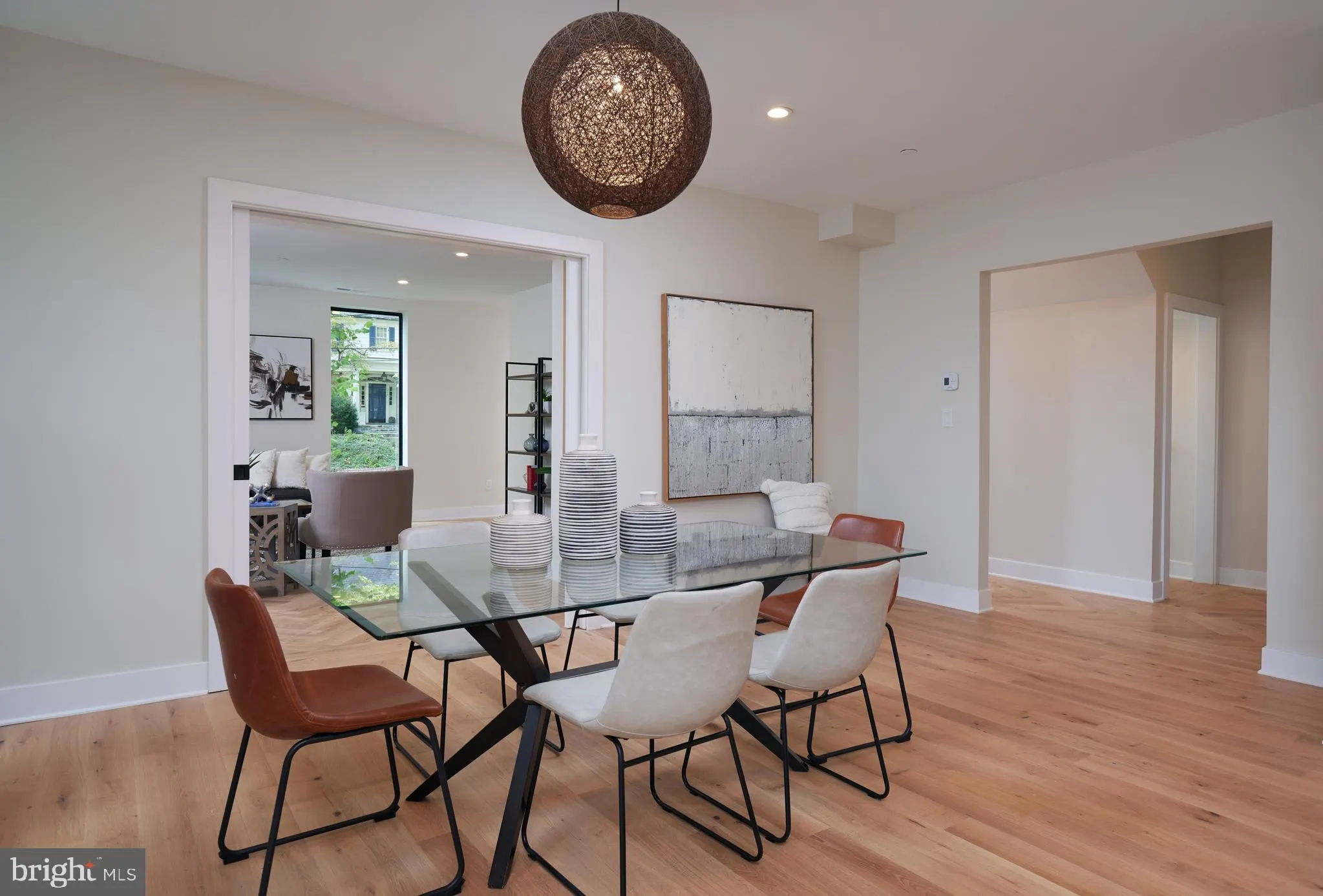 Dining area with glass table and mixed upholstered chairs