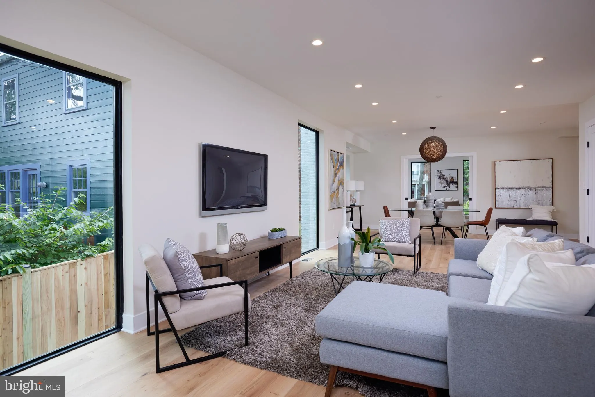 Living room with dual seating areas and access to outdoor deck