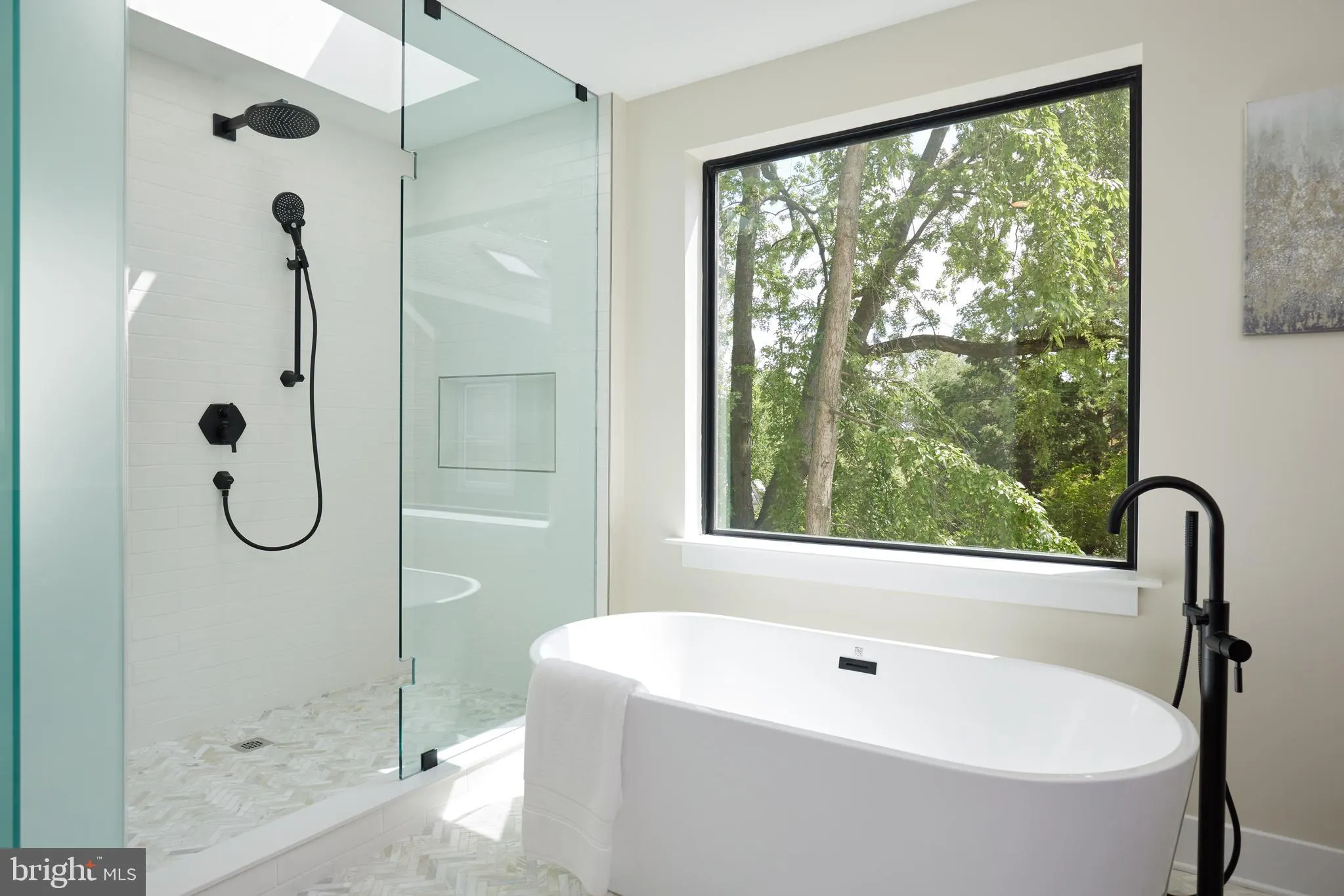 Bathroom with walk-in shower, freestanding tub, and black fixtures