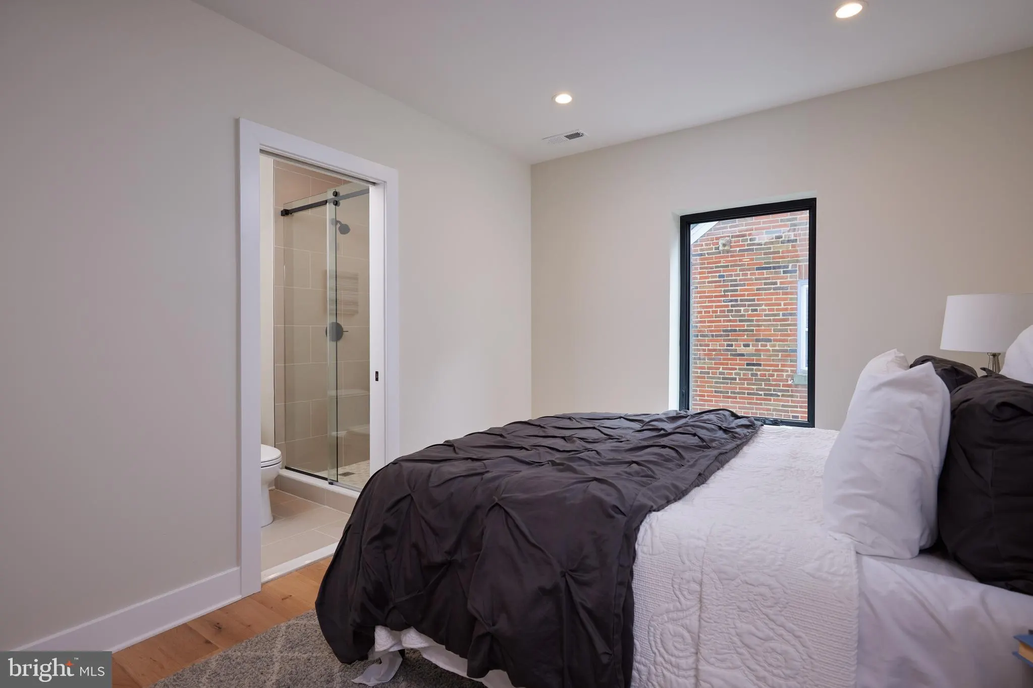 Bedroom with ensuite bathroom, black and white bedding