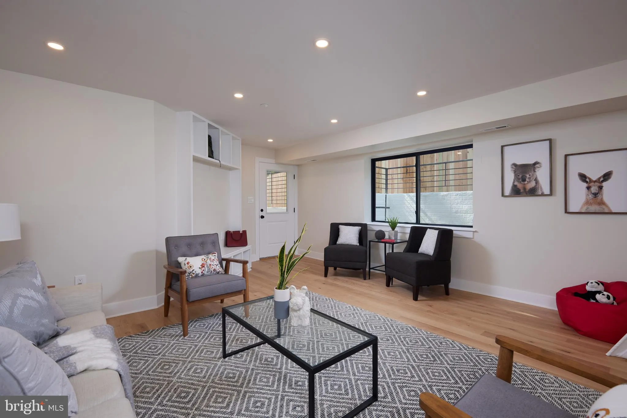 Family room with contemporary seating and wood flooring