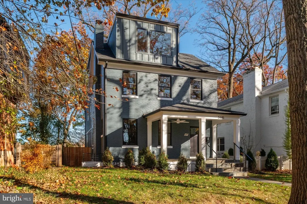 Contemporary home exterior with dark siding and modern dormer window