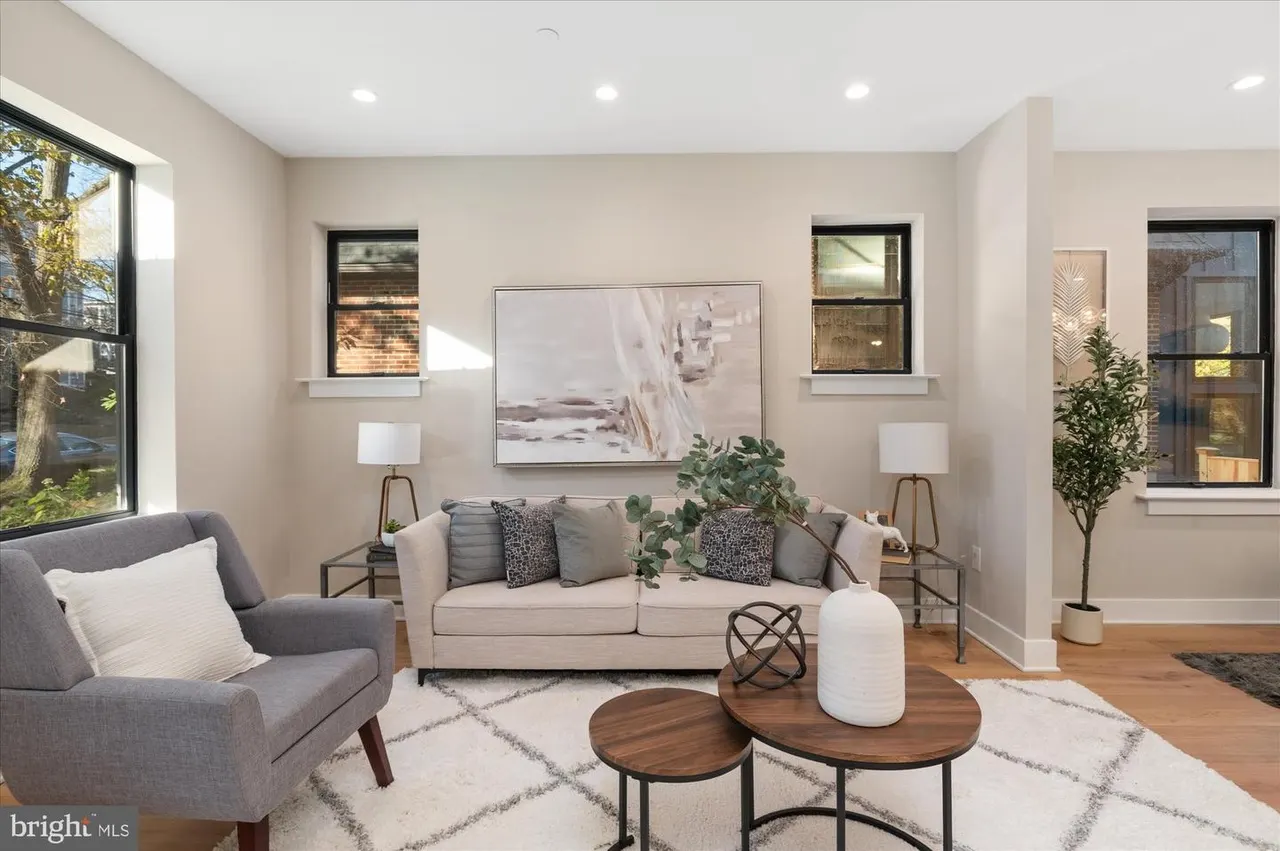 Living room with beige sofa, gray armchair, and wood coffee tables