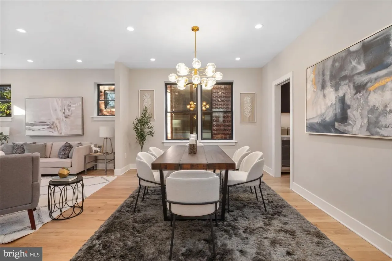 Combined living and dining space with sofa, dining table, and large windows