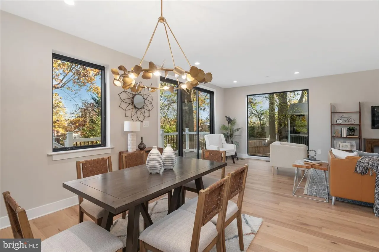 Dining room with dark table, wood chairs, and brass pendant chandelier