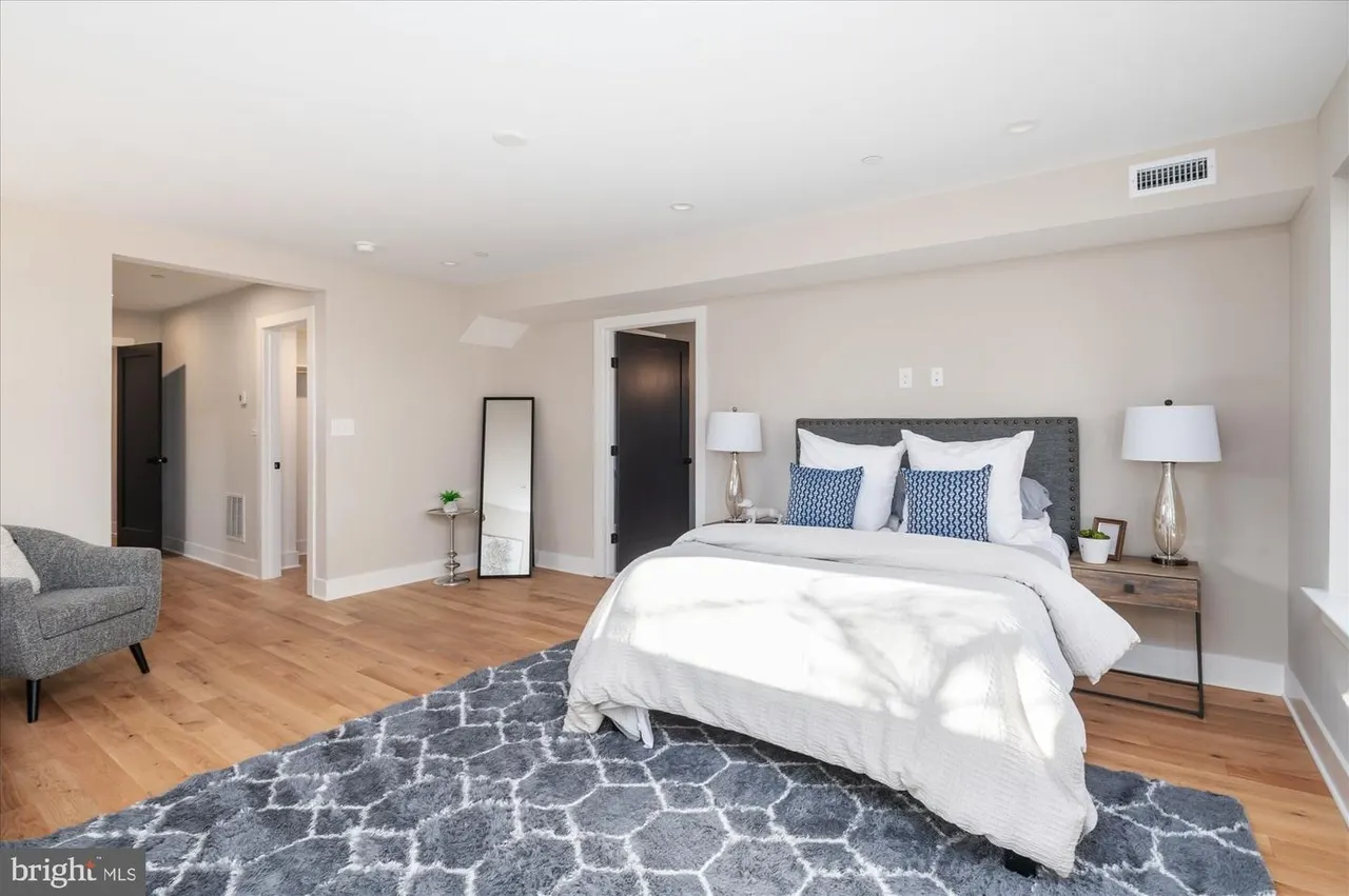Secondary bedroom with gray headboard and natural light from windows