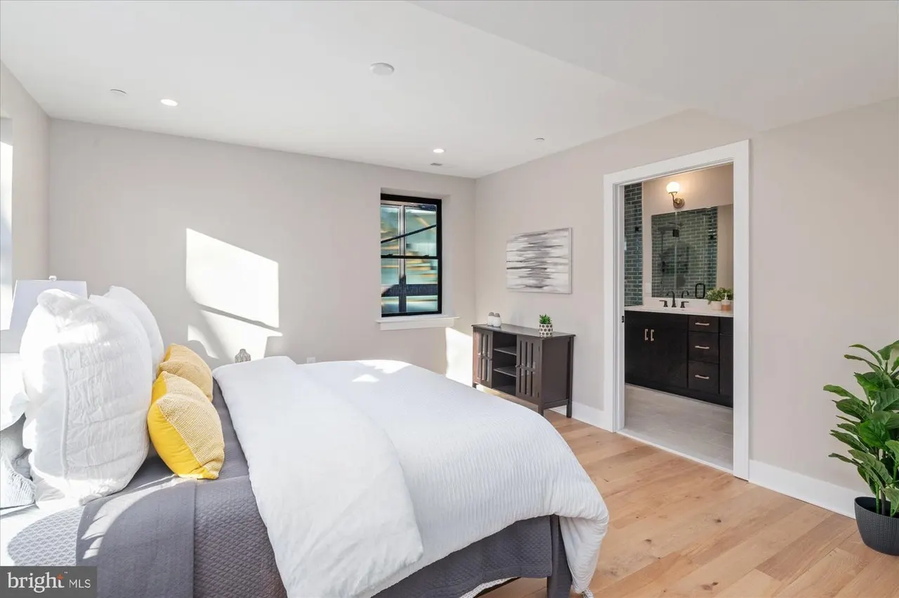 Bedroom with ensuite bathroom visible through doorway