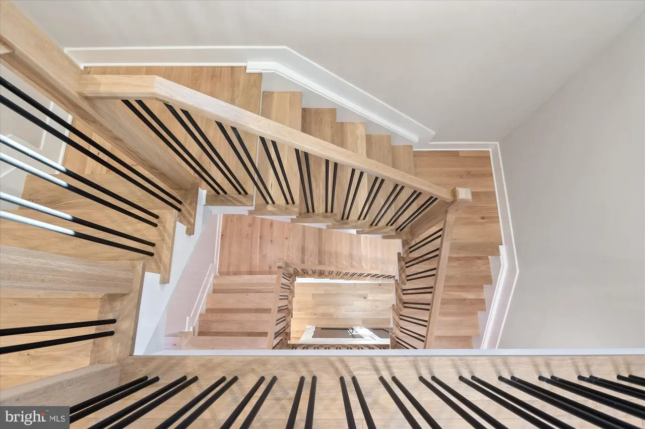 Overhead view of staircase with wood steps and metal railings