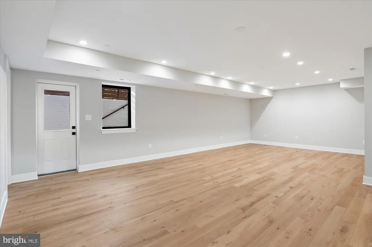 Finished basement space with wood floors and exterior door