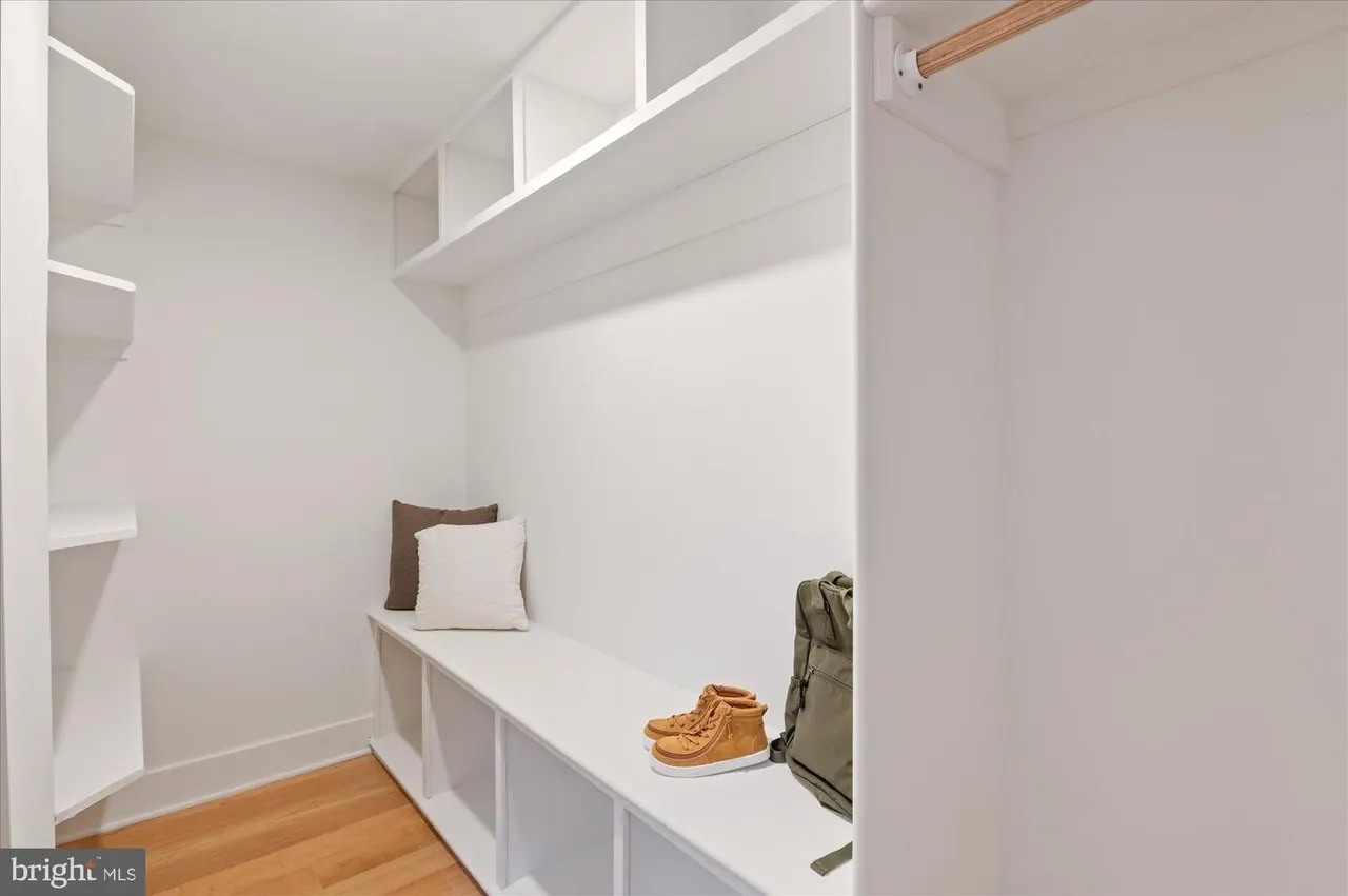 Mudroom with built-in shelving, bench seating, and open cubbies