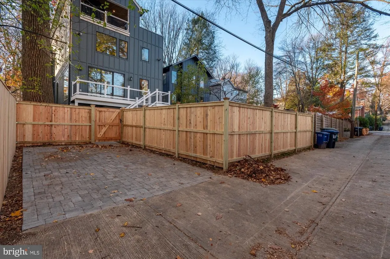 Patio with brick pavers and wooden privacy fence