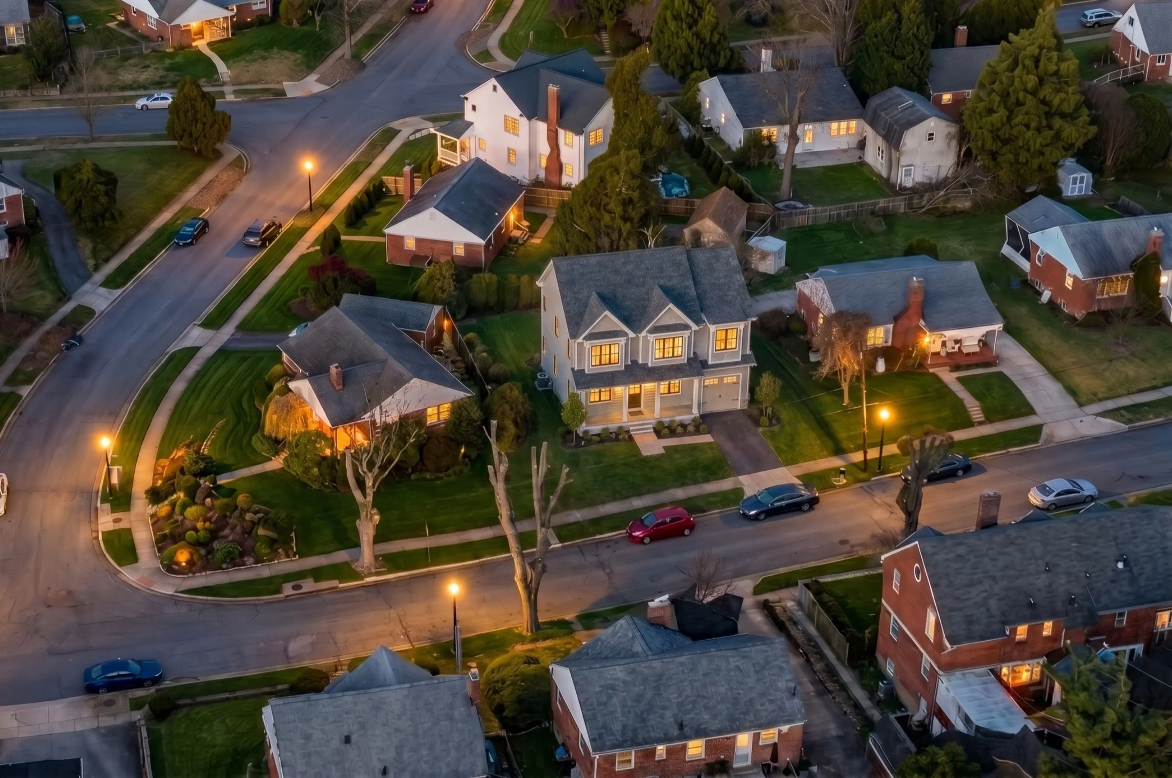 Aerial dusk view of 4915 Bangor Drive centered in its Kensington block amid tree-lined streets