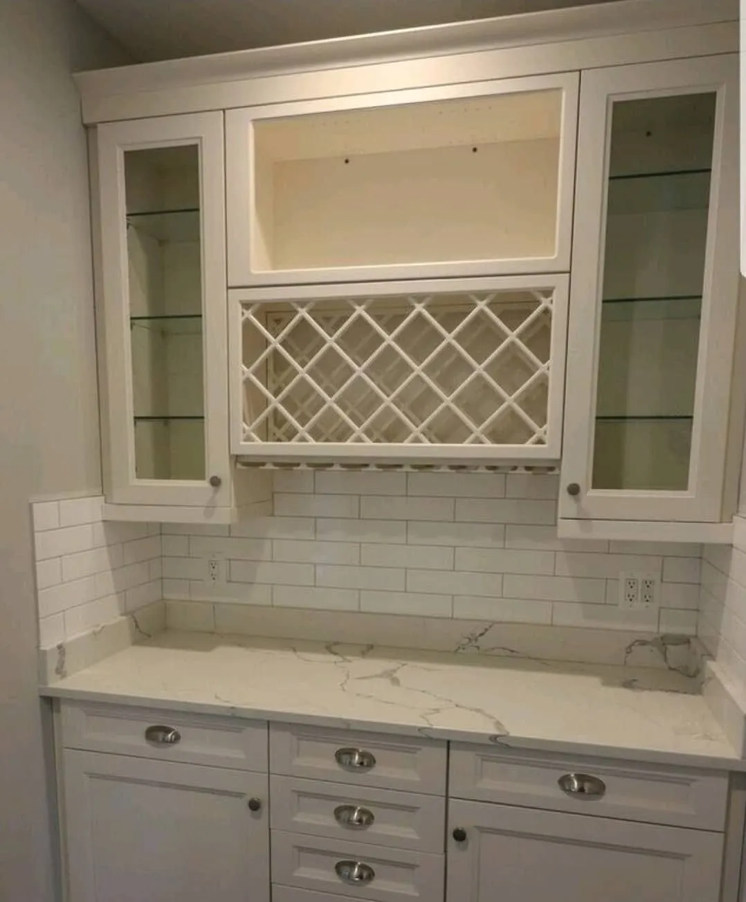 Butler's pantry with wine rack, glass cabinets, quartz counter