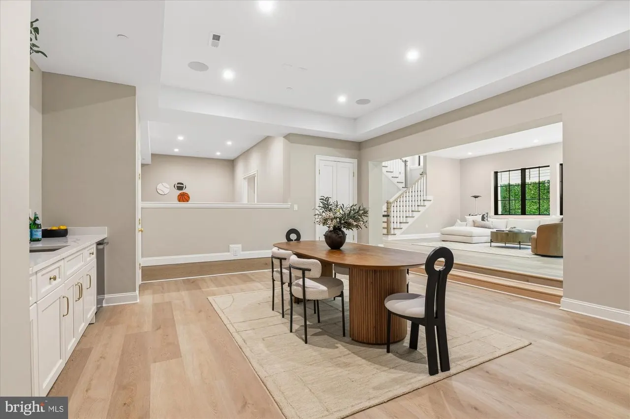 Dining area with wood table and open kitchen view beyond