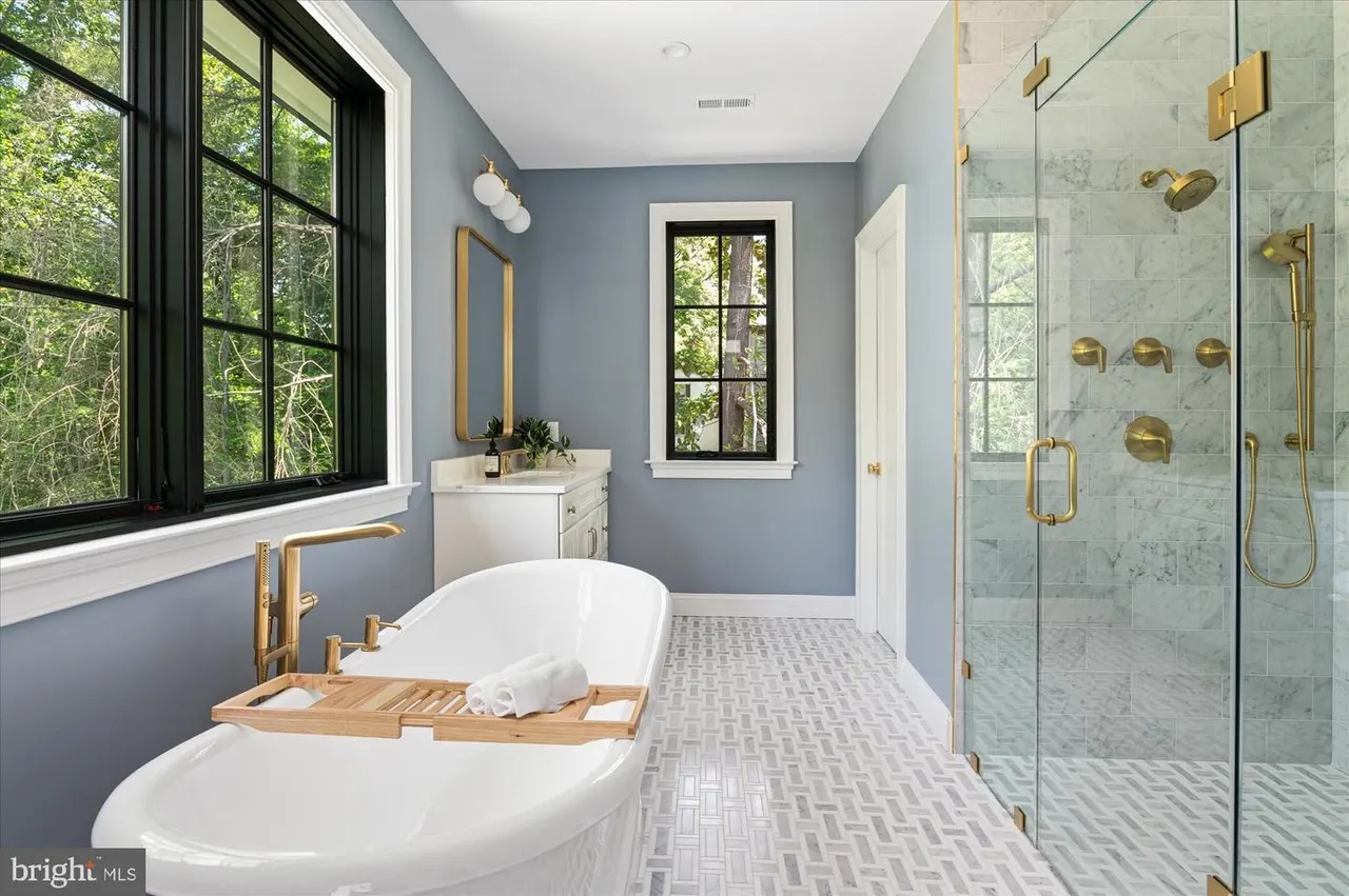 Luxury bathroom with dual soaking tubs, walk-in shower, and marble tiles