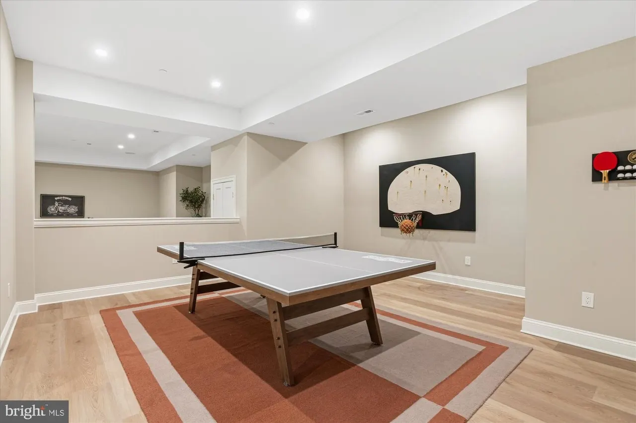Basement recreation room with ping pong table and basketball hoop
