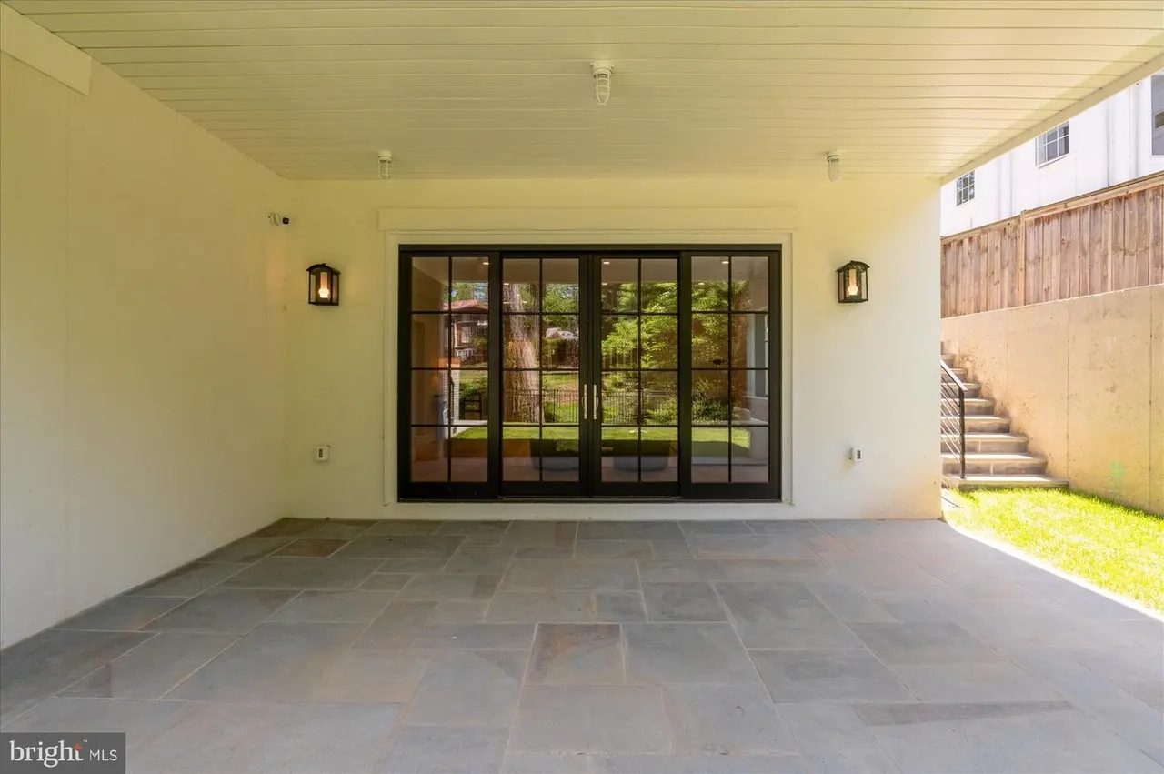 Screened porch with black multi-panel doors and patio