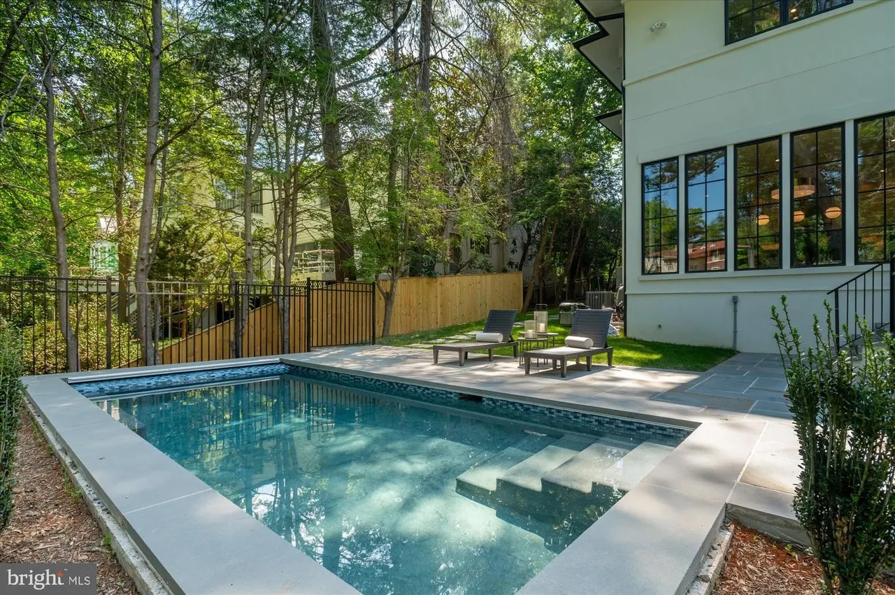Pool with integrated steps and modern patio seating area