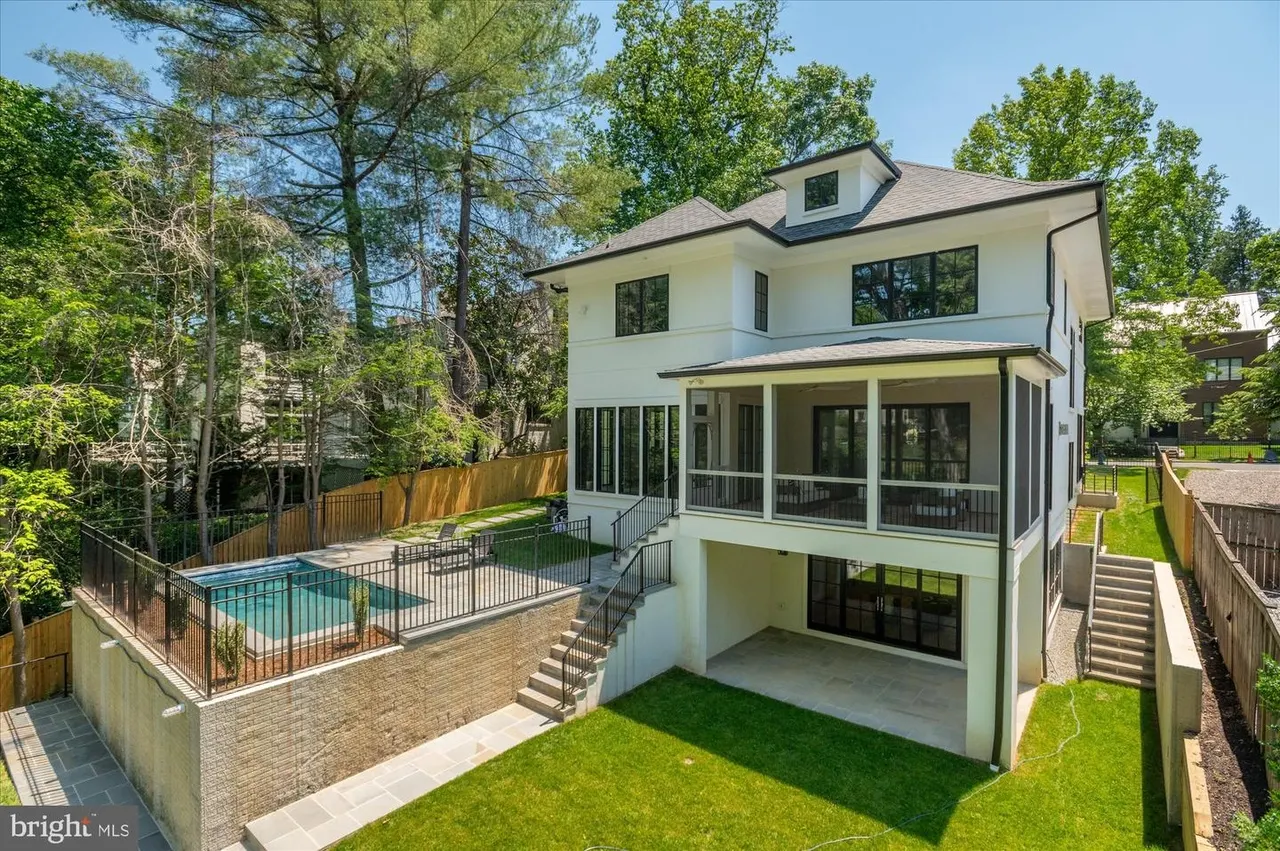 Two-story white modern house with pool and screened porch