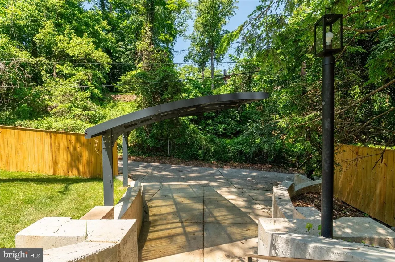 Modern pergola and patio deck in backyard setting
