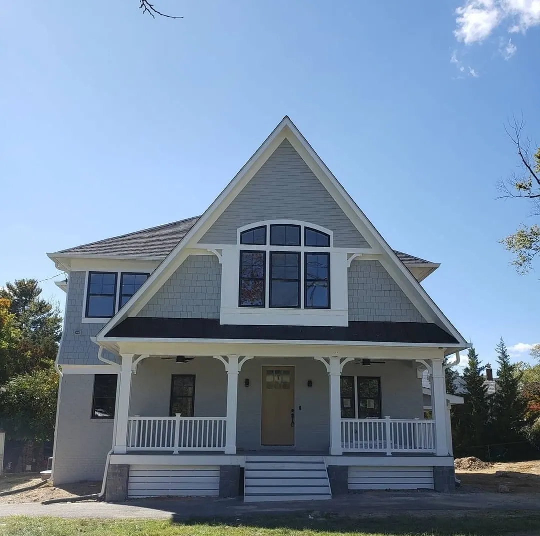 Front elevation with steep gable, white columns, and covered porch