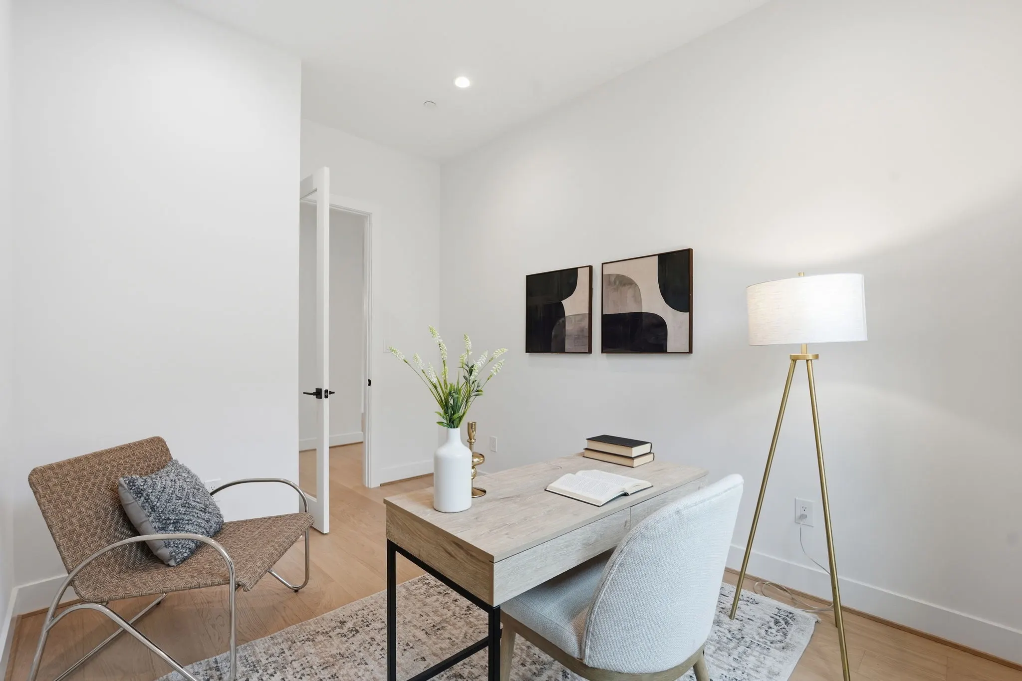 Office space with desk, woven chair, and built-in shelving
