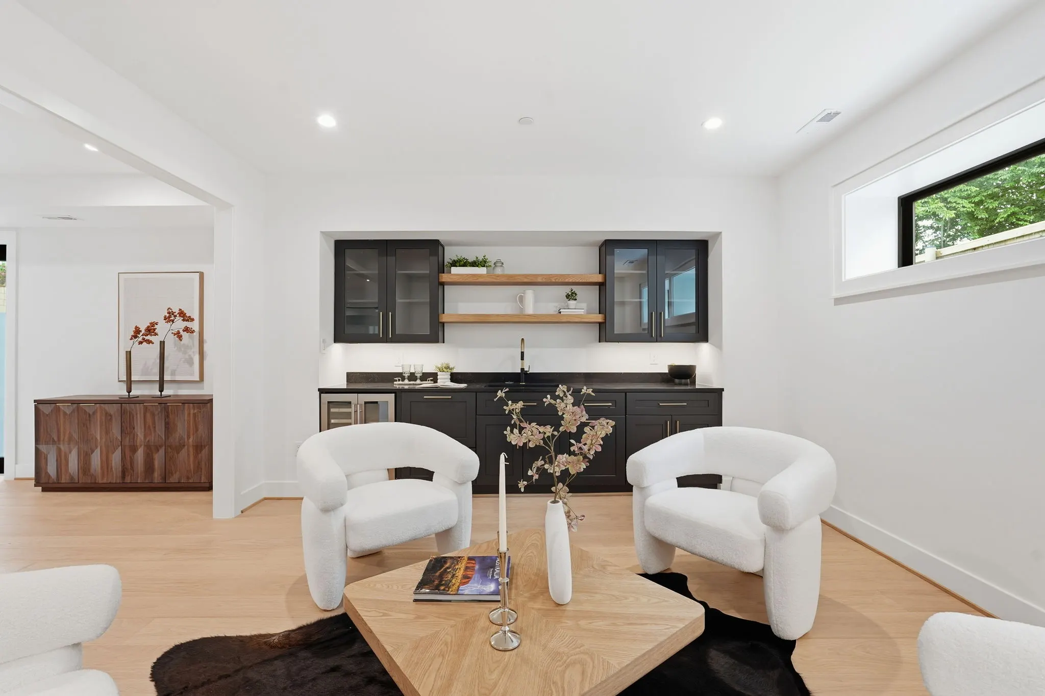 Lounge space with wet bar, wood sideboard, and contemporary furnishings