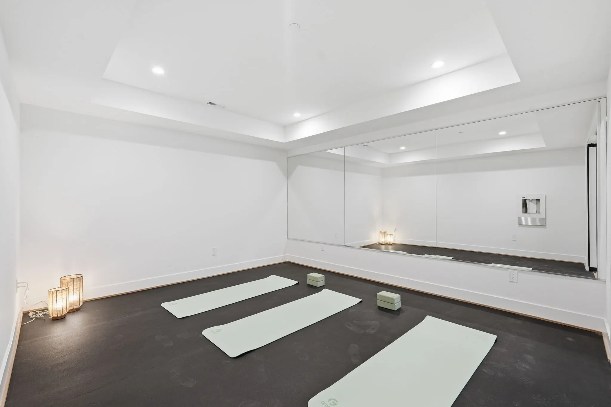 Fitness room with yoga mats and mirrored wall panels