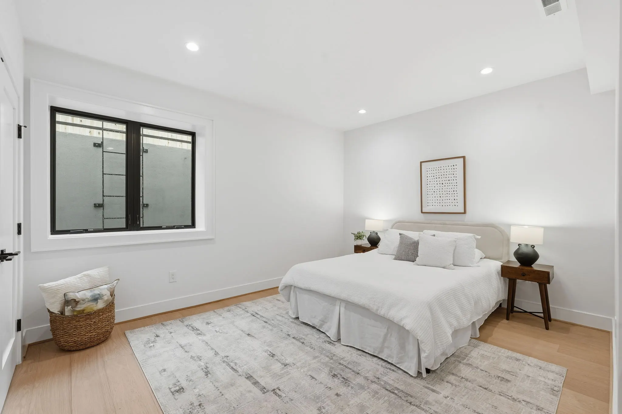 Bedroom with white bedding and casement window
