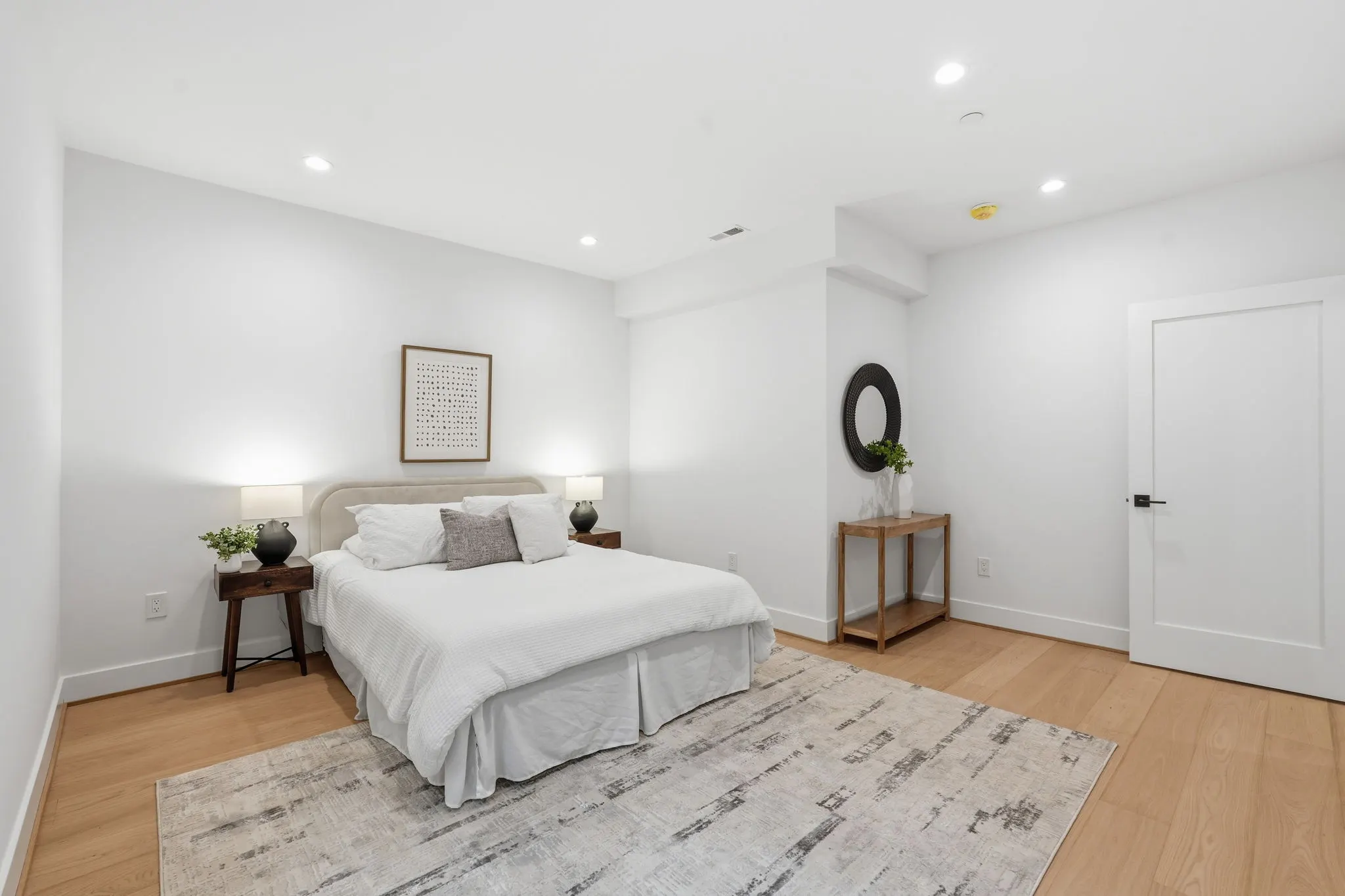 Bedroom with white bed and wooden nightstands