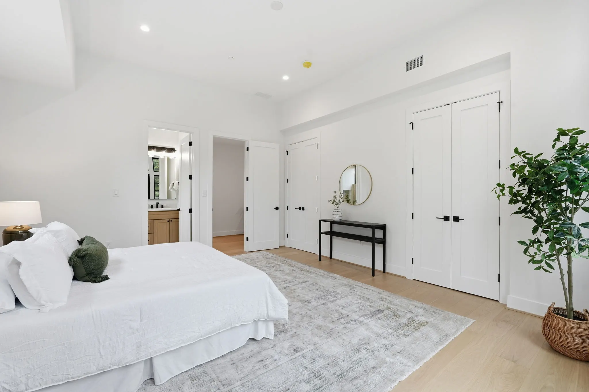 Primary bedroom with ensuite bathroom and white closets
