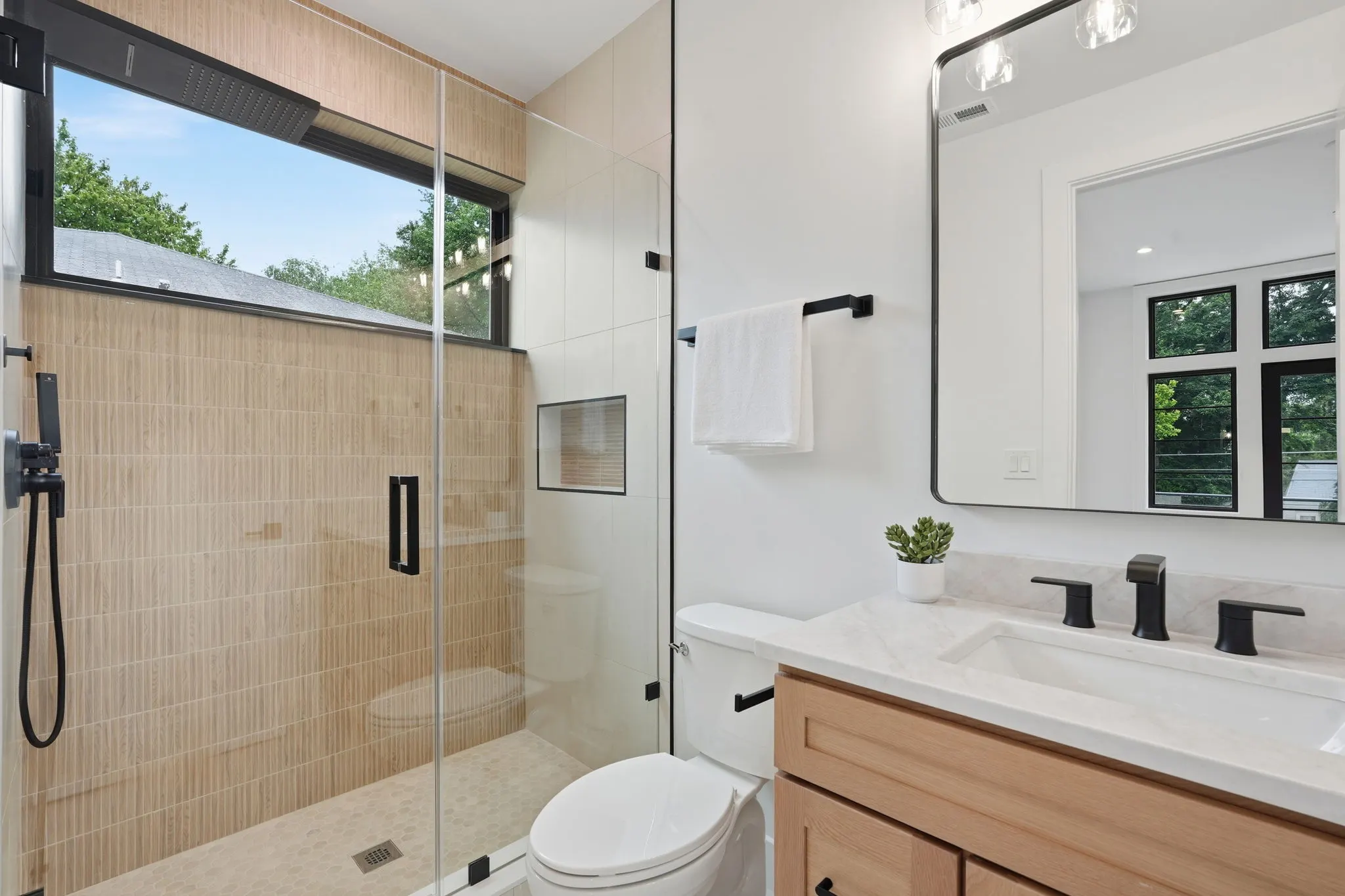 Bathroom with wood tile shower and white vanity