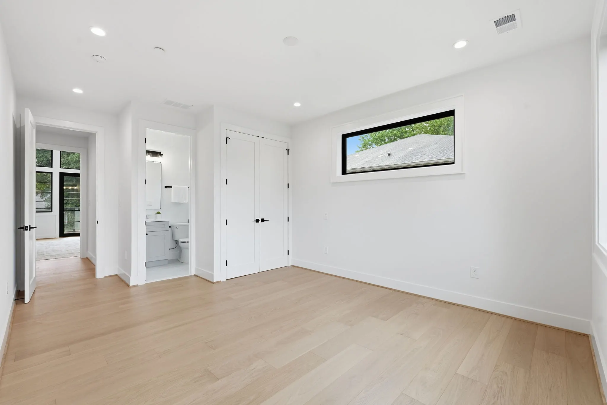 Hallway with white doors and wood flooring