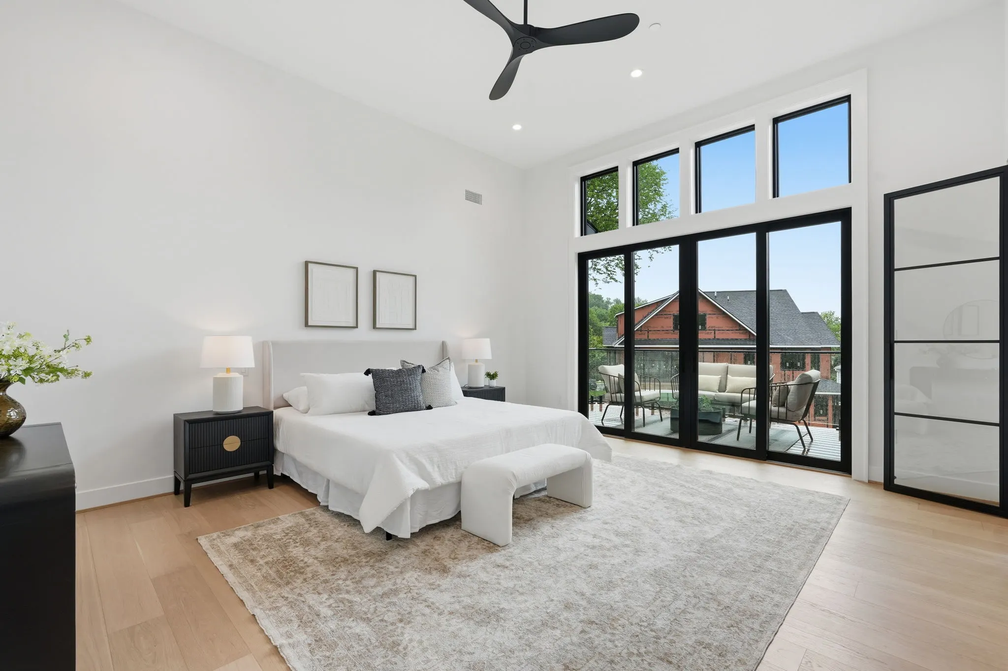 Primary bedroom with glass doors to outdoor patio
