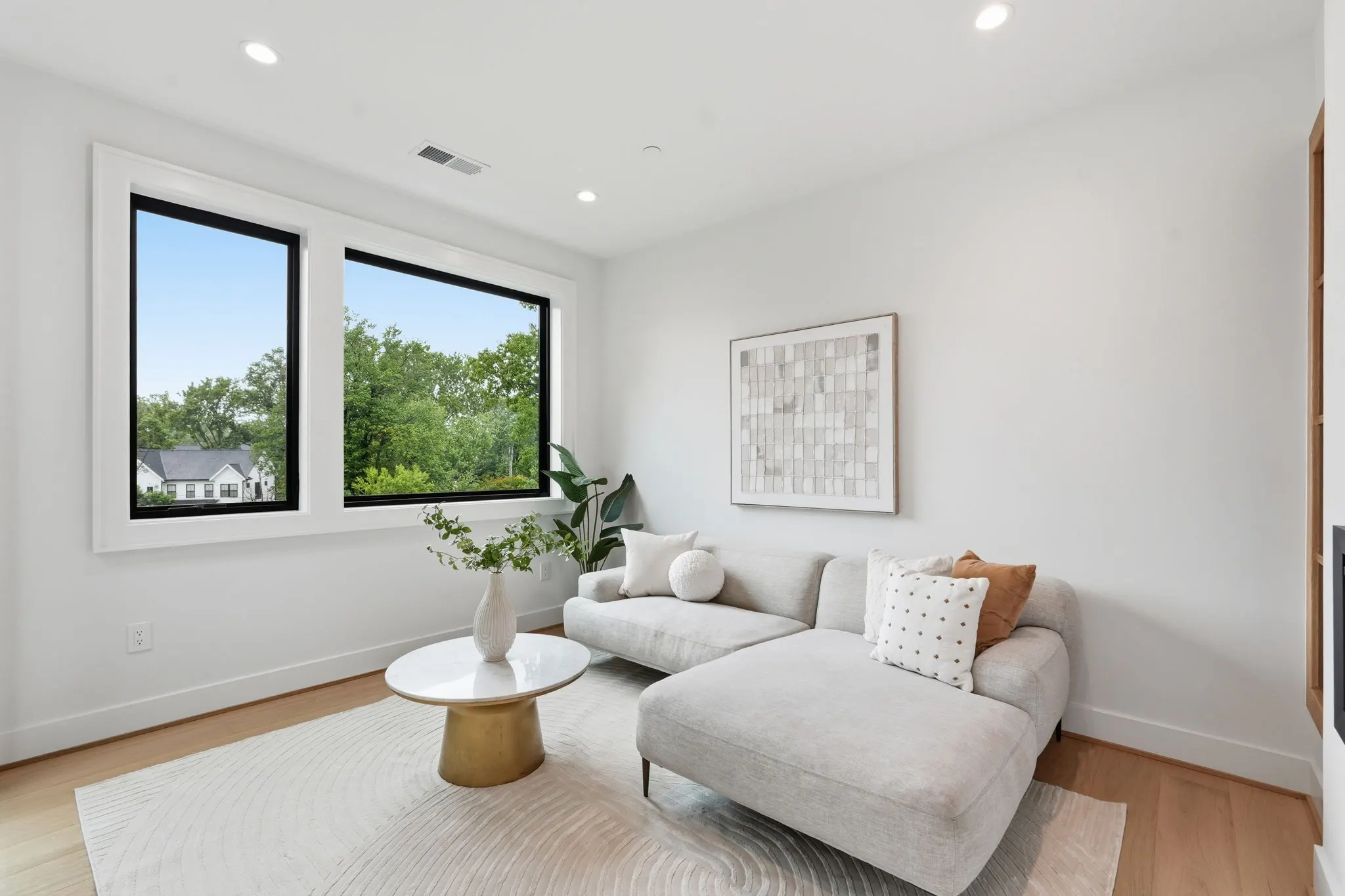 Sitting area with gray sectional sofa and brass accent table