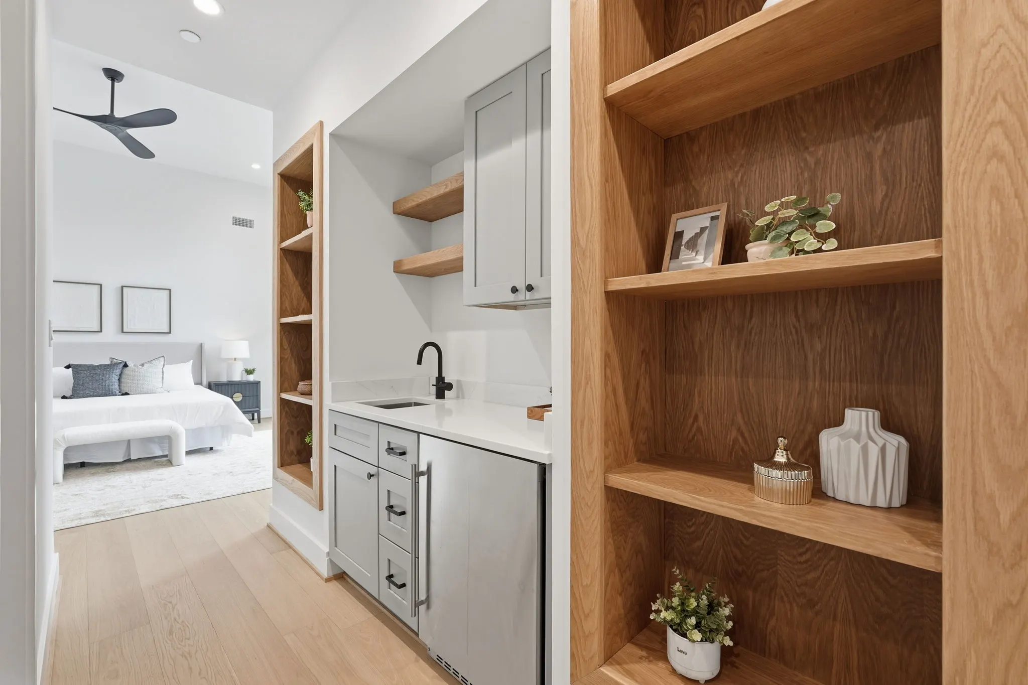 Bathroom with vanity and wood shelving wall storage