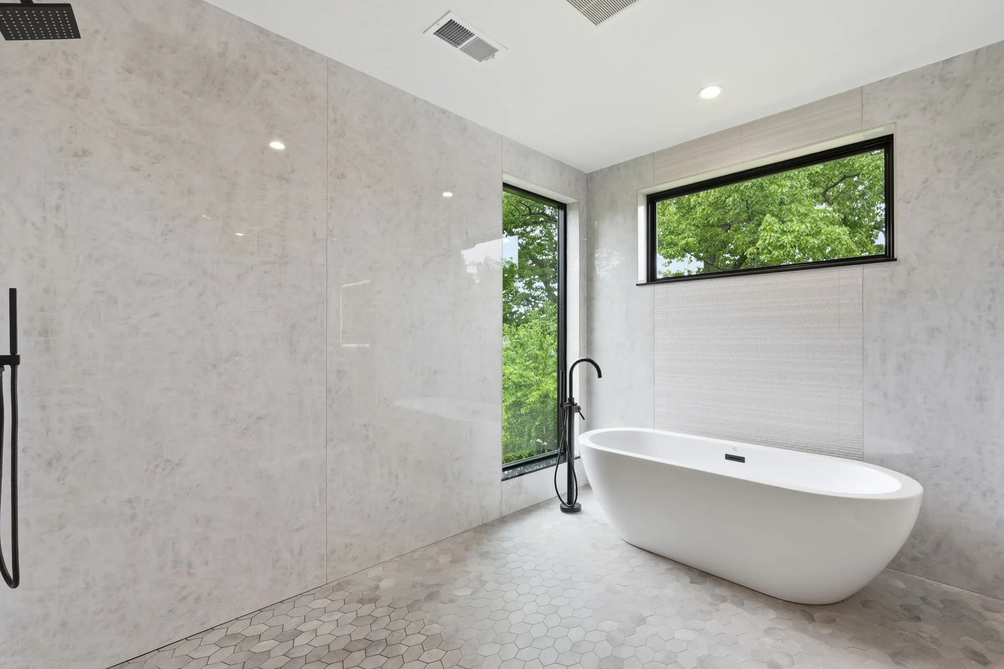 Modern bathroom with freestanding tub and frameless shower