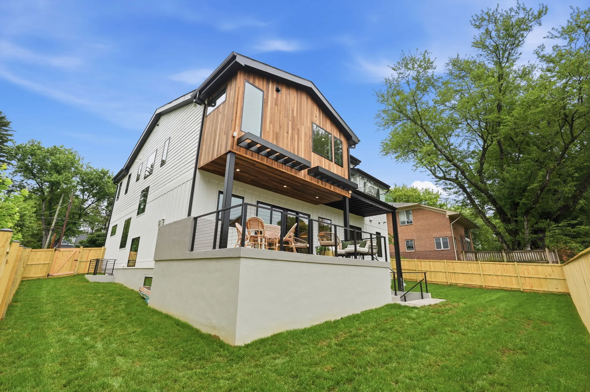 Modern farmhouse with mixed siding and large deck
