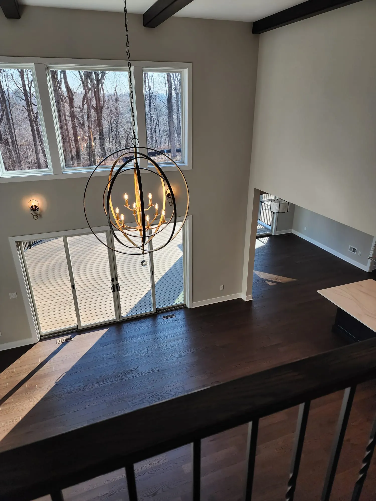 Great room and orb chandelier seen from upstairs balcony