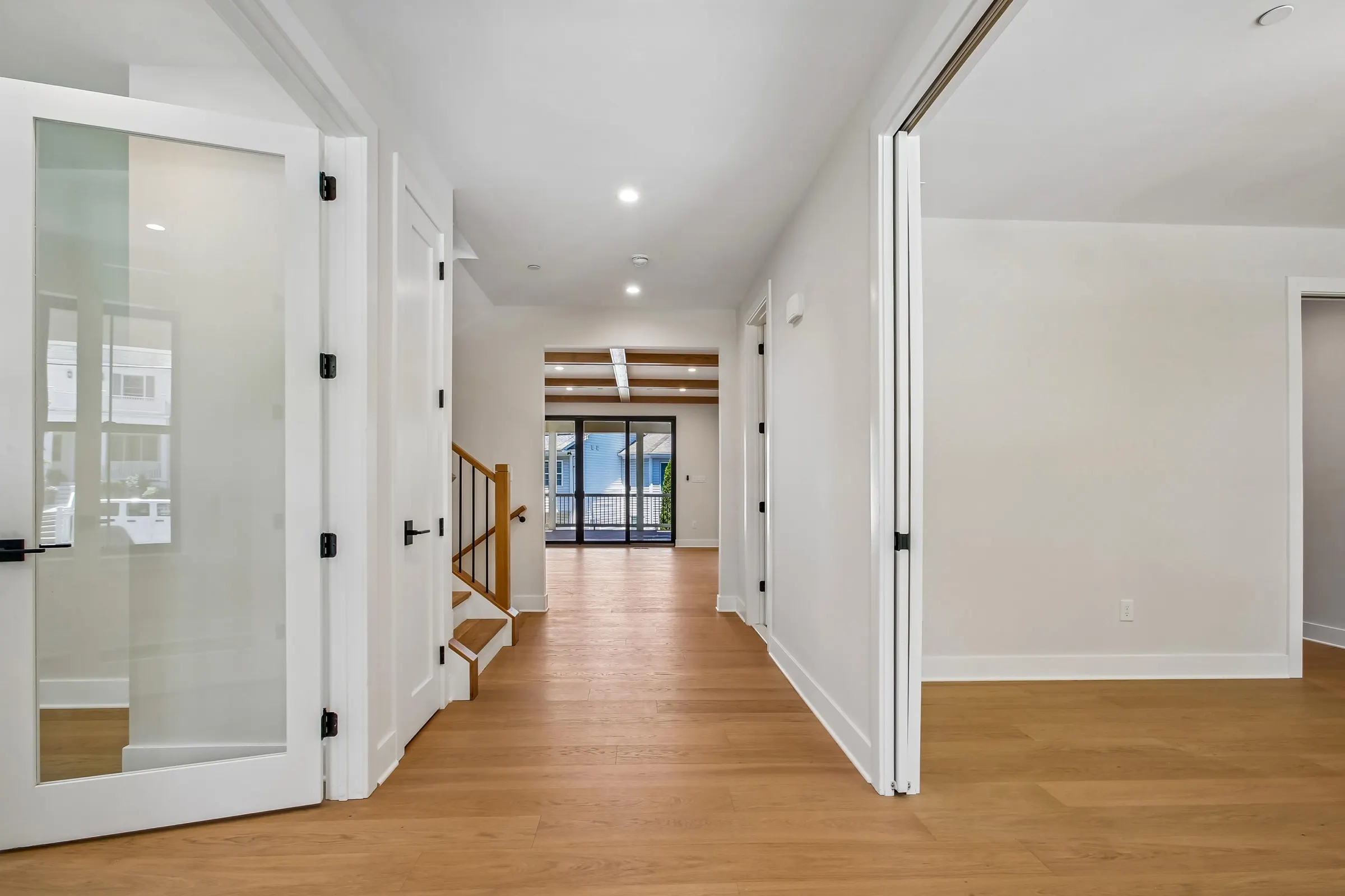 Foyer of 6003 Melvern Dr with white oak floors and a glass-paneled office door, a Colonial new build
