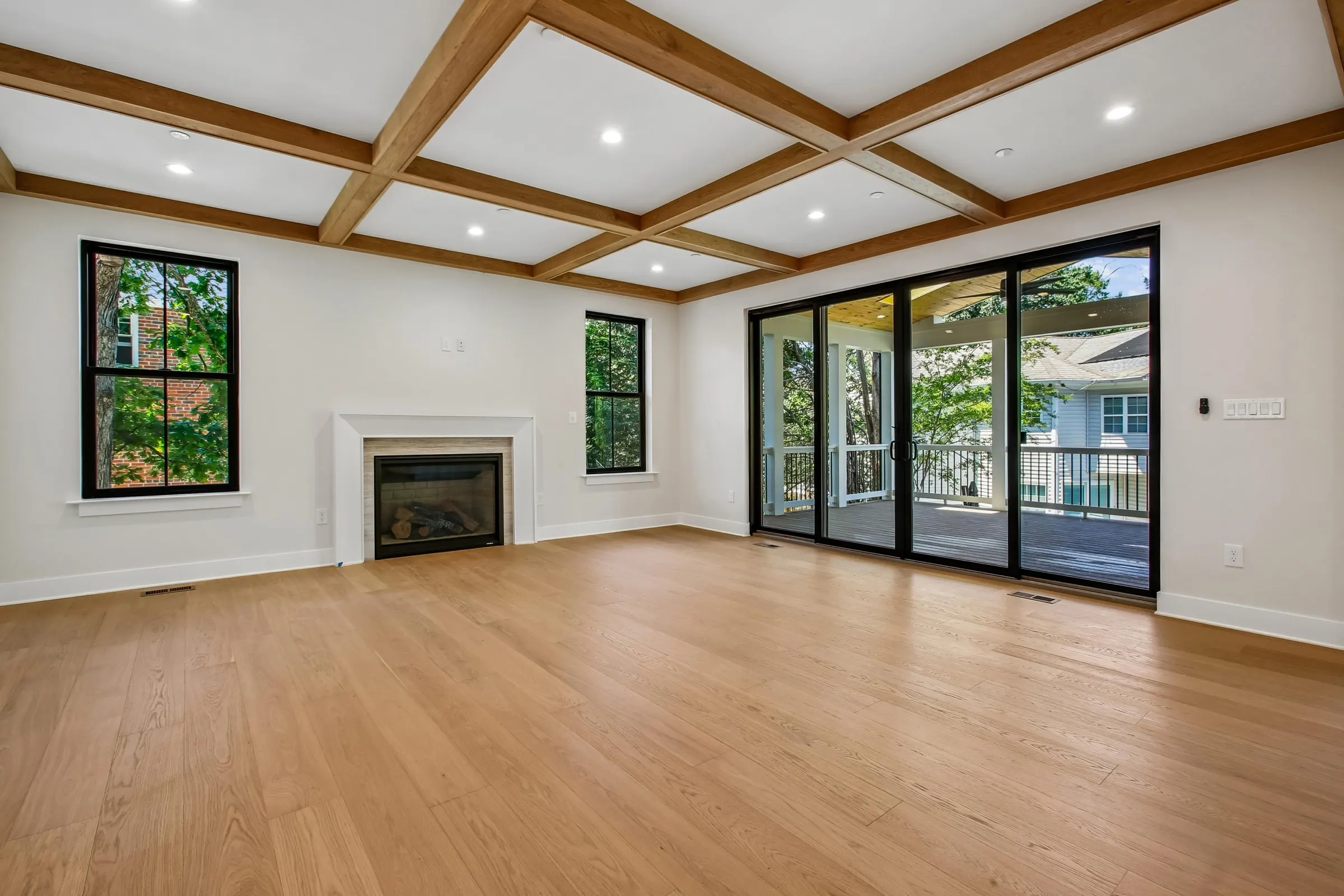 Living room of 6003 Melvern Dr, a Colonial build, with the kitchen open to the main living space