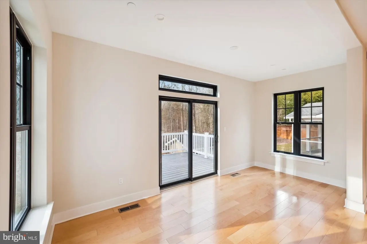 Bright room with glass doors opening to deck and windows