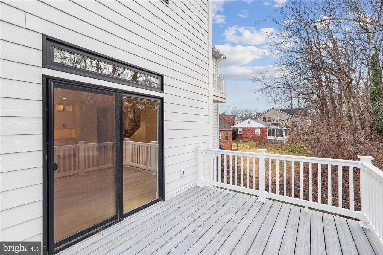 Deck with black sliding glass doors and white railings