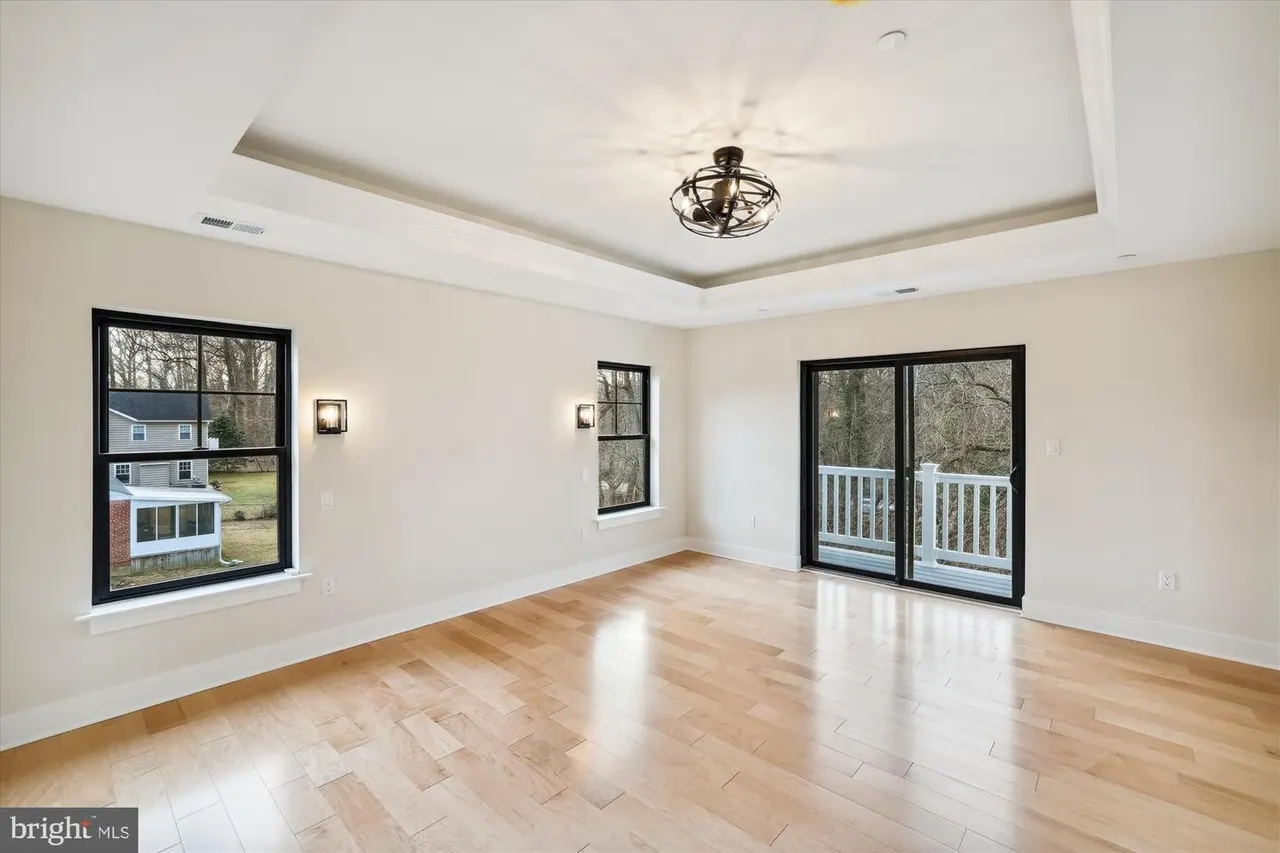 Open living room with coffered ceiling and glass doors to patio